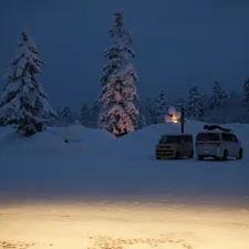 A van parked in the snow at night related to Camping Beds for a Cozy Night Under the Stars: Walmart Options