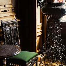a vase and chair in a room related to Masterpiece Cast Iron Chimineas at Home Depot