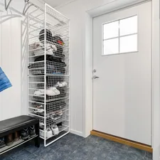 A walk in closet with a coat rack and shoes related to Elevate Your Entryway: The Ultimate Guide to Entryway Shoe Benches
