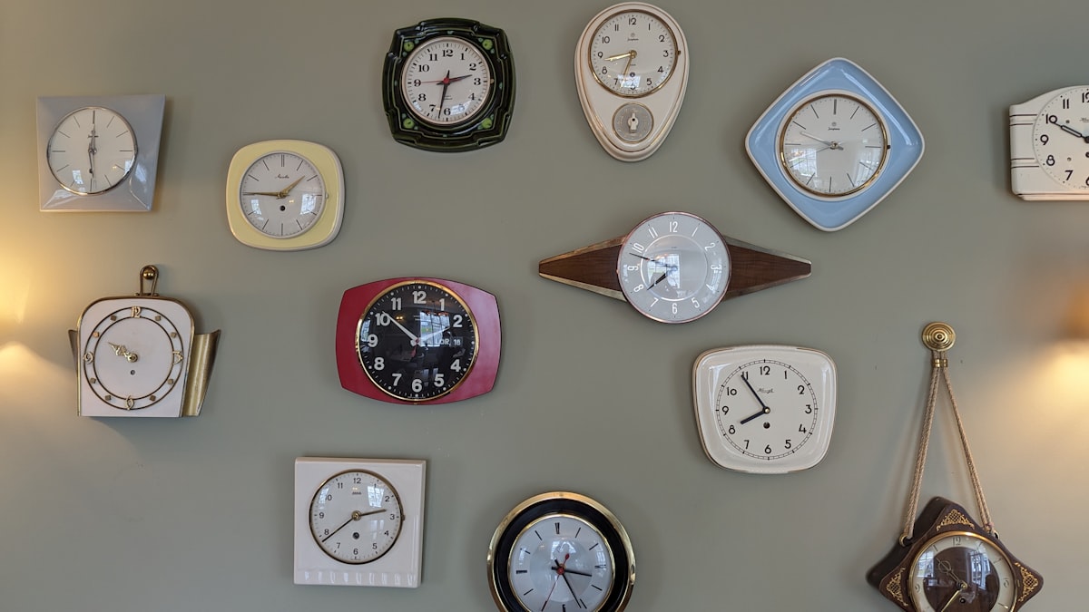 a wall with many different clocks on it related to The Ultimate Guide to Clocks from Bed Bath & Beyond