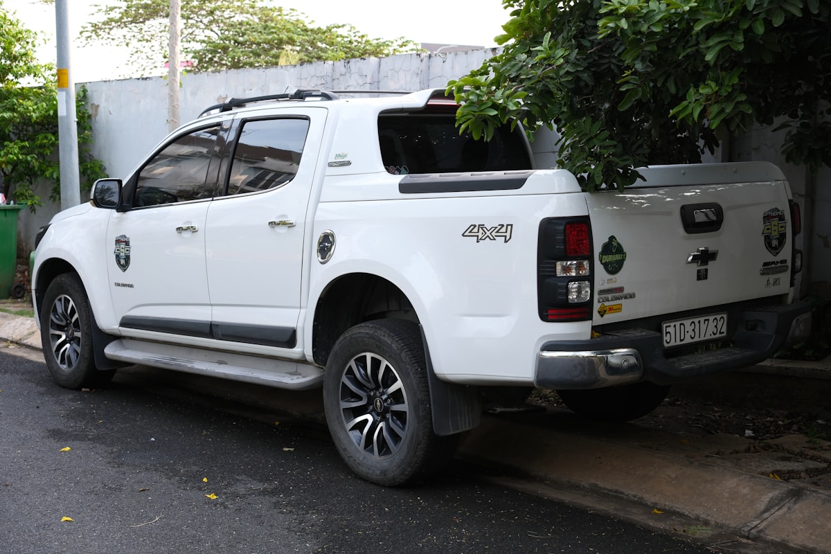 A white pickup truck is parked on the street. related to Exploring the GMC Canyon Bed Dimensions