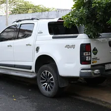 A white pickup truck is parked on the street. related to Exploring the GMC Canyon Bed Dimensions