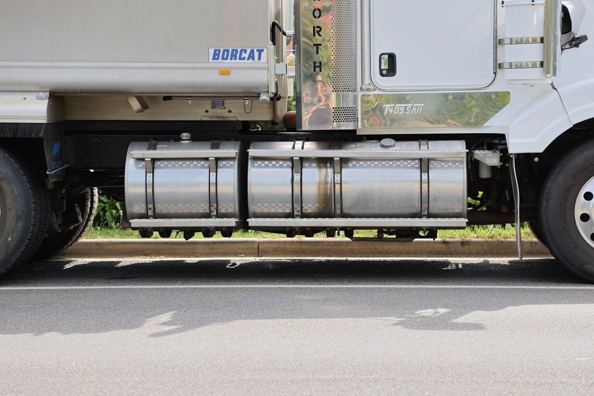 A white semi truck parked on the side of the road related to Maximizing Efficiency with Steel Flatbed Truck Beds
