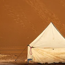 A white tent stands in a vast desert landscape related to The Ultimate Guide to Choosing the Right Bed Bug Tent