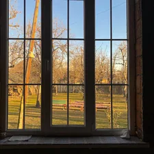 a window with a view of a field and a crane related to DIY Window Valances: Elevate Your Home Decor