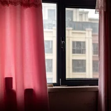 a window with red curtains related to Elevate Your Windows with Curtain Swags and Valances