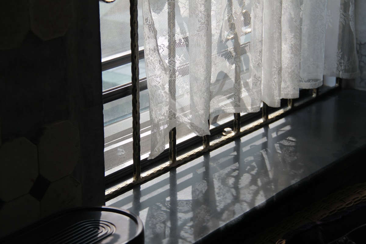 a window with white curtains and a fan related to Kitchen Valance Curtains