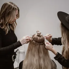 a woman getting her hair styled by another woman related to Level Up Your Style with Stunning Valence Scarf Ideas