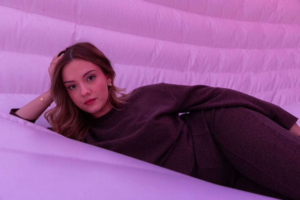 A woman is posing on a purple inflatable surface. related to The Ultimate Guide to Inflatable Sofa Beds