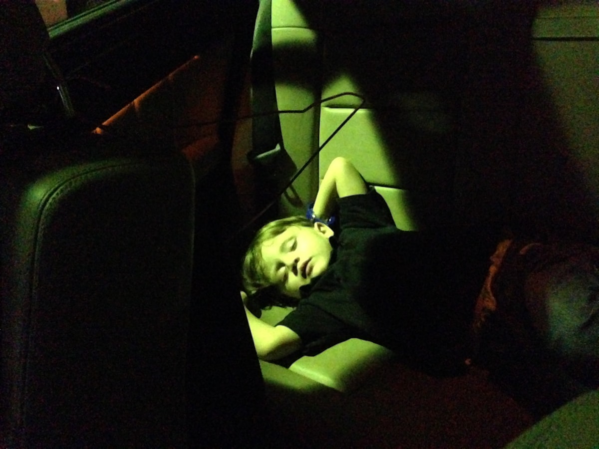 a woman laying down in a car seat related to Transforming Travel: The Ultimate Guide to Car Seat Beds