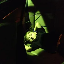 a woman laying down in a car seat related to Transforming Travel: The Ultimate Guide to Car Seat Beds