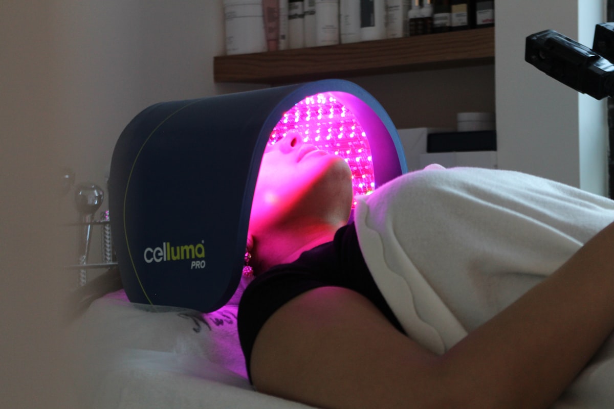 A woman laying on a bed with her head on a pillow related to The Ultimate Guide to Home Tanning Beds