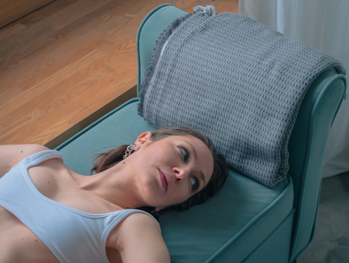a woman laying on a couch with a pillow related to Elevate Your Sleep: Air Mattress Options at Bed Bath and Beyond