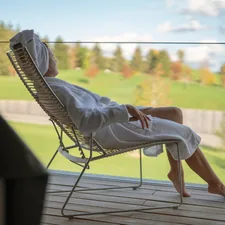 a woman sitting in a chair looking out a window related to Escape to Serenity: Discover the Ultimate Bed and Breakfast Spa Experience