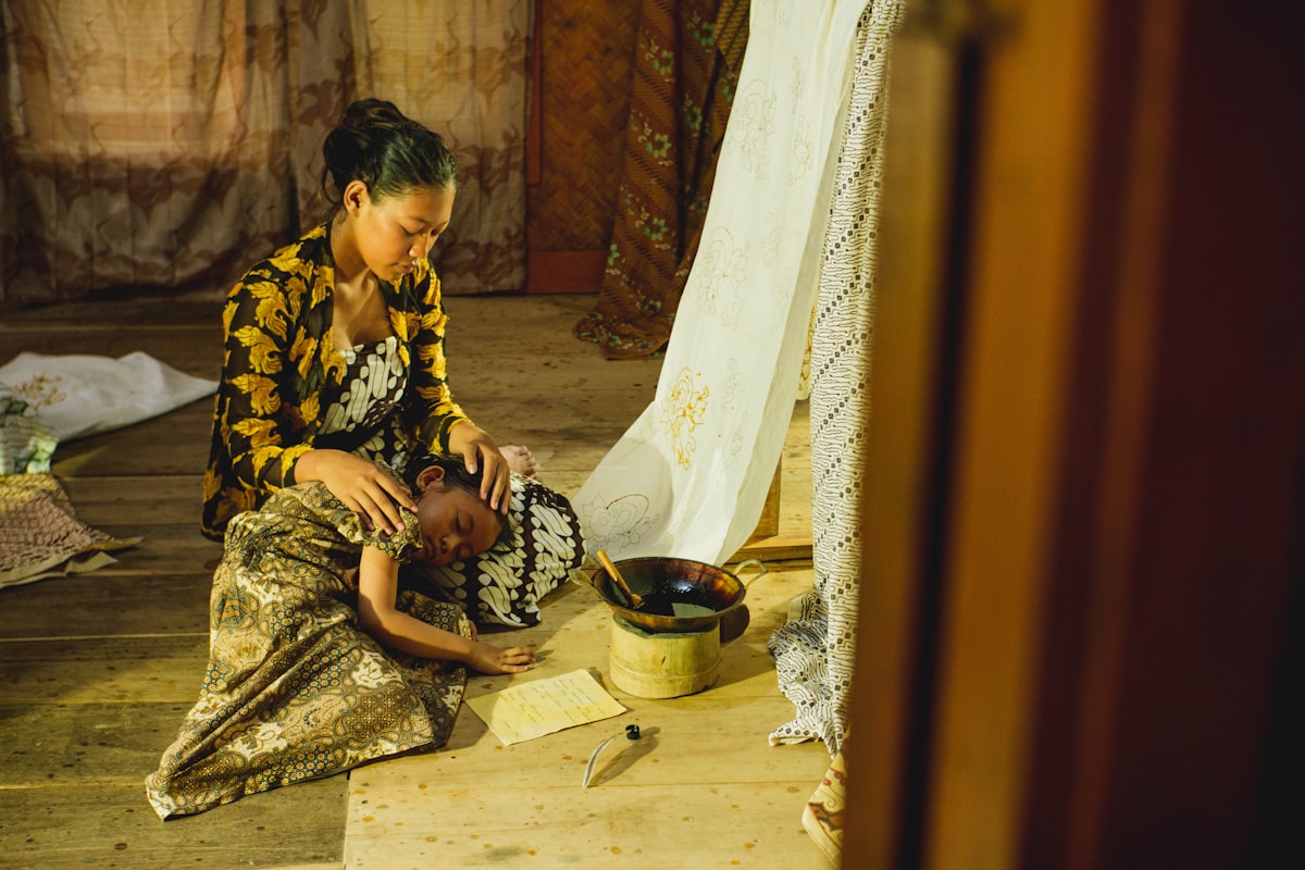 a woman sitting on the floor with a child related to Embracing Comfort and Tradition: The Enduring Appeal of Legacy Home Bedding