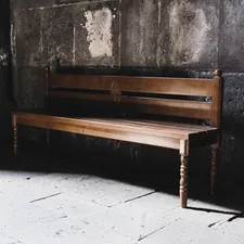 a wooden bench sitting in front of a stone wall related to Revamping Your Home with Corner Entryway Benches