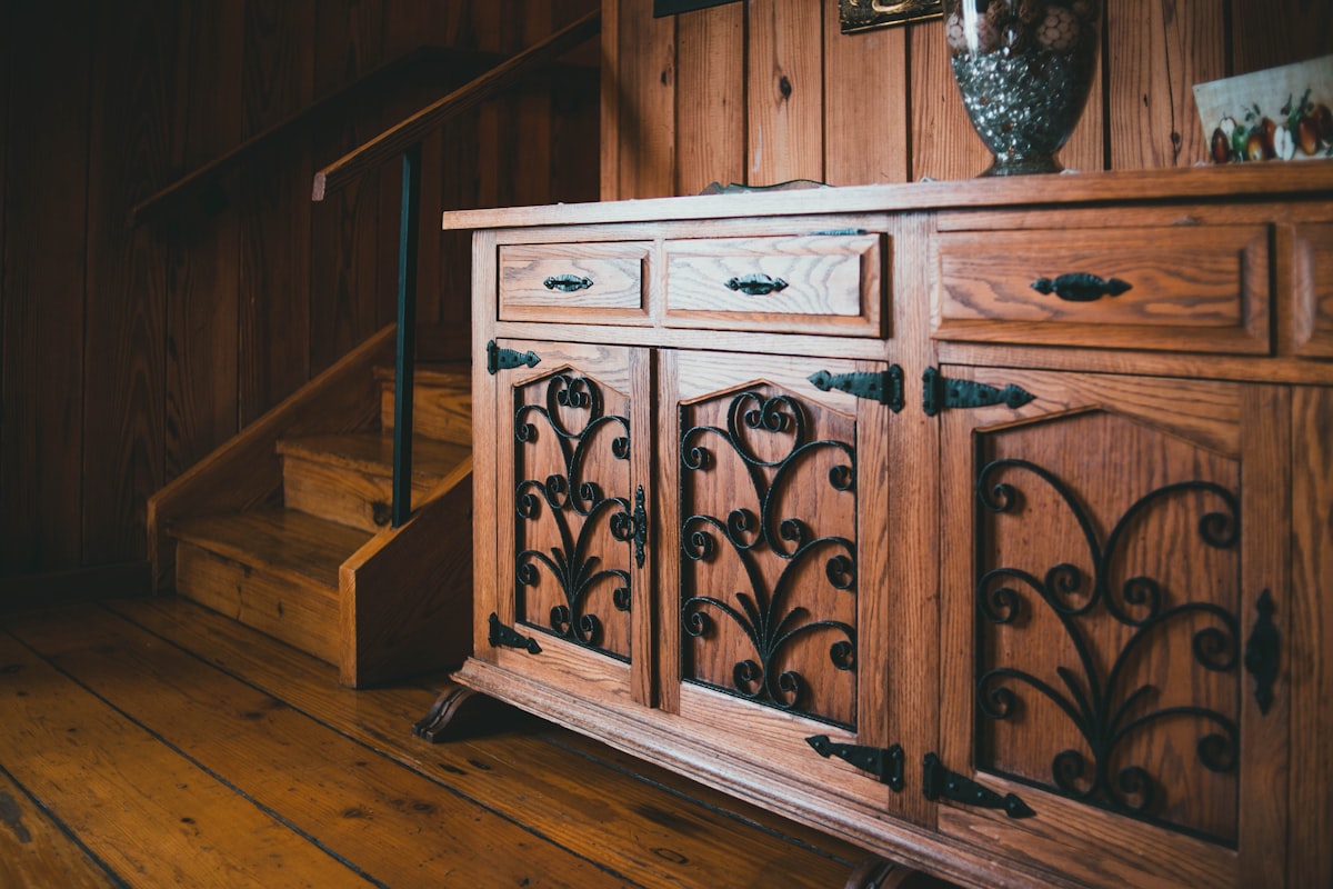 a wooden cabinet with ornate carvings on it related to Elegant Dining with an Antique Sideboard Buffet
