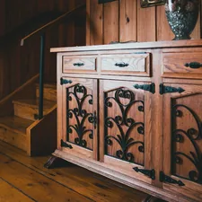 a wooden cabinet with ornate carvings on it related to Elegant Dining with an Antique Sideboard Buffet