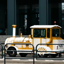 a yellow and white truck parked in front of a building related to Affordable Train Toddler Bed