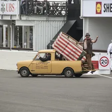 a yellow truck carrying a giant american flag related to Top Flags for Truck Beds: Show Off Your Style and Utility