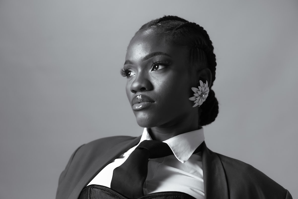 A young black woman in a suit and tie related to Elegance Defined: White Tie Up Valance Curtains