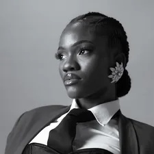 A young black woman in a suit and tie related to Elegance Defined: White Tie Up Valance Curtains