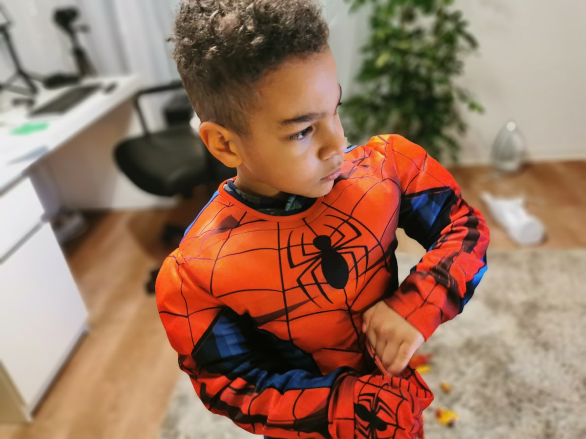 a young boy wearing a spider man costume related to Transform Your Child's Room with a Heroic Bed