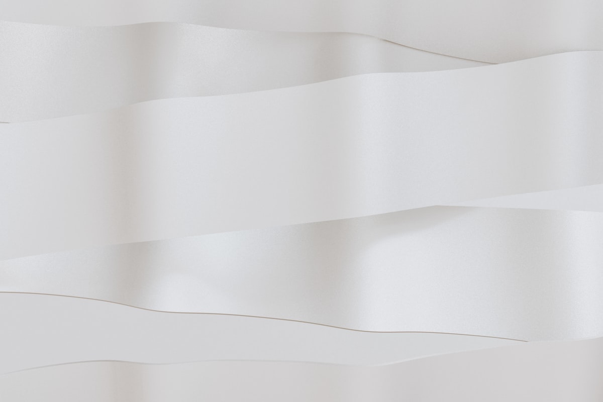 Abstract white folds create a minimalist design. related to Envisioning Elegance: The Allure of a White Bed Canopy