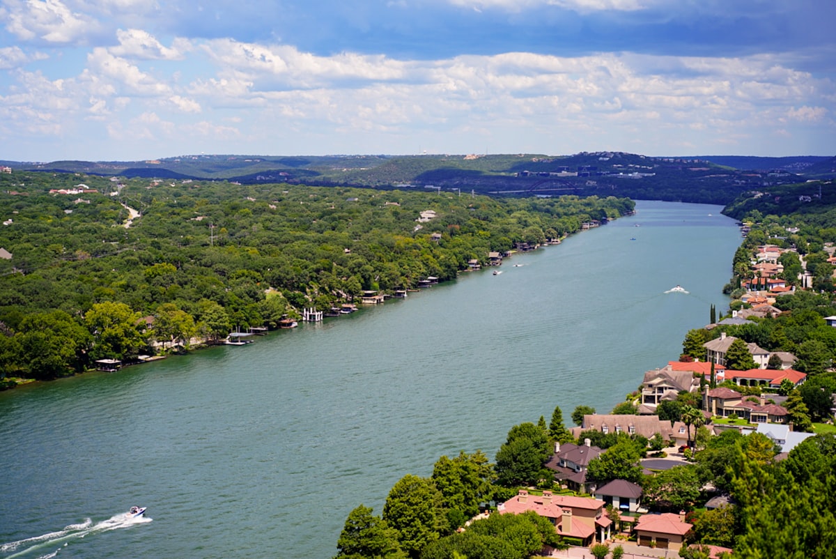 aerial view of green trees near body of water during daytime related to Discover the Charm of Austin, TX: Top Bed and Breakfasts You Can't Miss