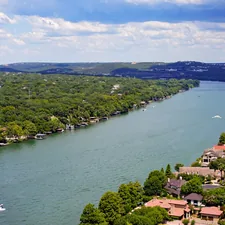 aerial view of green trees near body of water during daytime related to Discover the Charm of Austin, TX: Top Bed and Breakfasts You Can't Miss