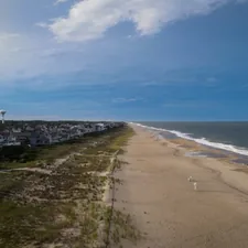 an aerial view of a beach with houses and a hot air balloon in the distance related to Exploring the Bed Bath and Beyond Experience in Delaware