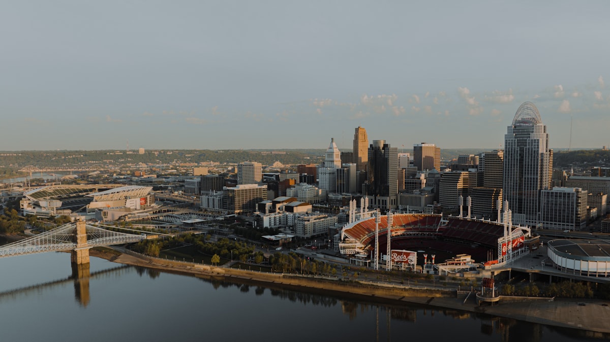 an aerial view of a city with a river running through it related to Score Big with Cincinnati Reds Bedding: A Home Run for Your Bedroom