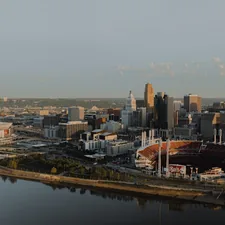 an aerial view of a city with a river running through it related to Score Big with Cincinnati Reds Bedding: A Home Run for Your Bedroom