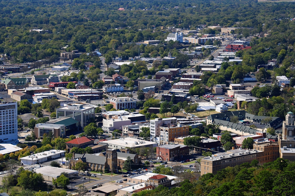 an aerial view of a city with lots of trees related to Charming Retreats in Hot Springs, Arkansas