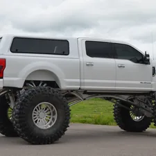 An Ekstensive built Ford Truck in white, a long way from Texas related to Protect Your Truck with Pickup Bed Caps: A Must-Have Accessory