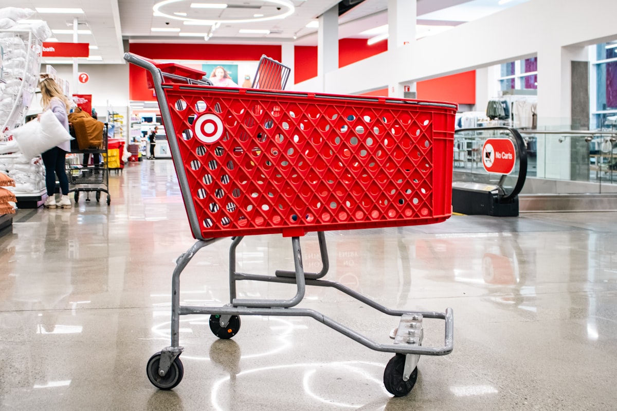 An empty red Target shopping cart within a Target store. related to Snuggle Up in Style: Explore the Ultimate Target Bedding Sets