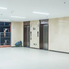 an empty room with two doors and a backpack on the floor related to Elevate Your Space: The Ultimate Guide to Lift Bed Frames