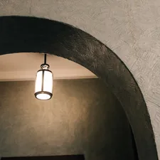 An illuminated lantern hangs under an archway. related to Illuminating the First Impression: Entryway Light Fixture Ideas