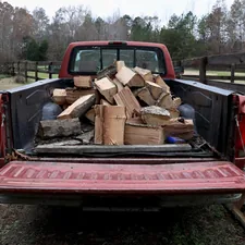 An old pickup truck loaded down with firewood. related to Enhance Your Pickup Truck's Utility with High-Quality Sideboards