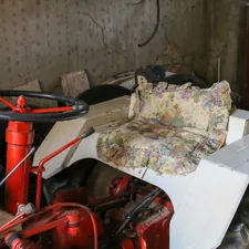 an old tractor with a floral seat cover related to Toddler Tractor Bed: The Perfect Sleep Solution for Little Farmers