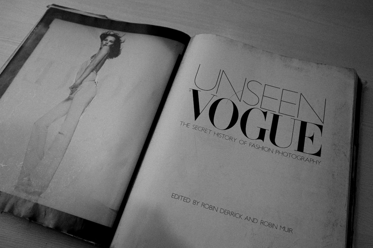 an open book with a picture of a woman in a dress related to Unveiling Luxury: The Enduring Appeal of Yves Delorme Coverlets