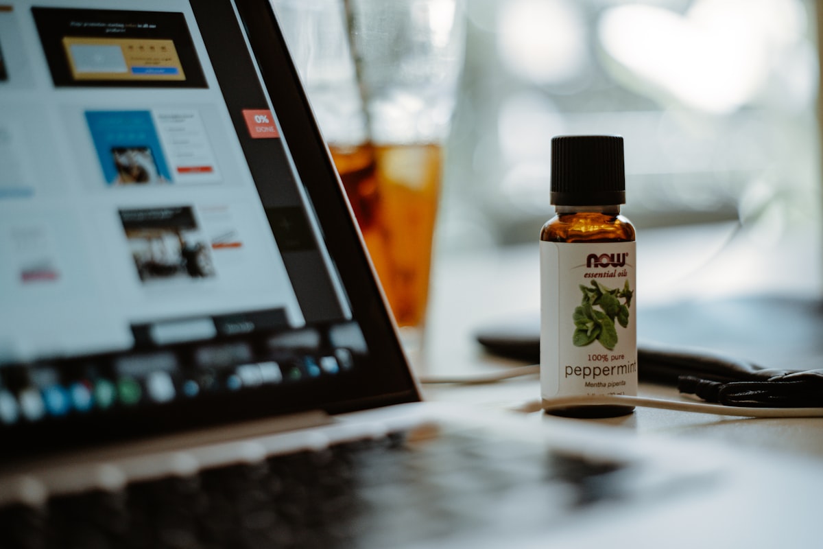 an open laptop computer sitting on top of a table related to Does Peppermint Oil Repel Bed Bugs? The Truth Behind the Myth