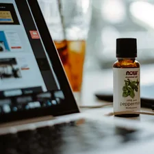 an open laptop computer sitting on top of a table related to Does Peppermint Oil Repel Bed Bugs? The Truth Behind the Myth