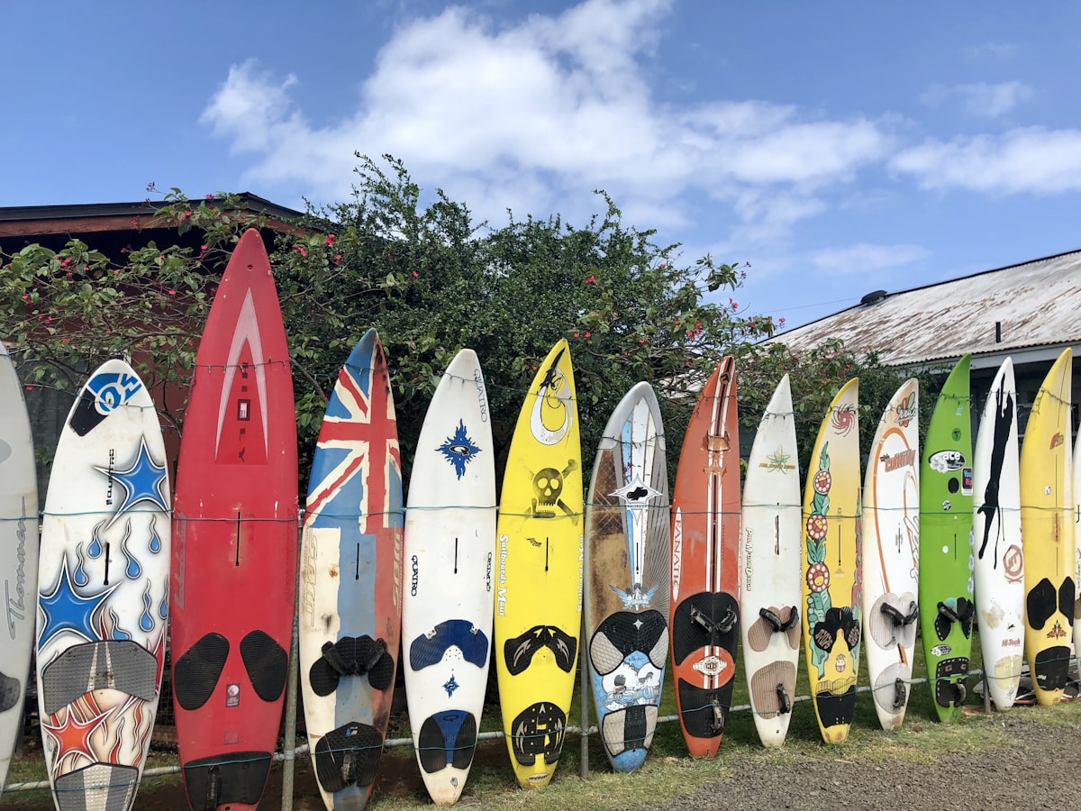 assorted-color surfboard standing under white and blue sky related to Second to None: Expertly Curated Second Hand Sideboards for Sale