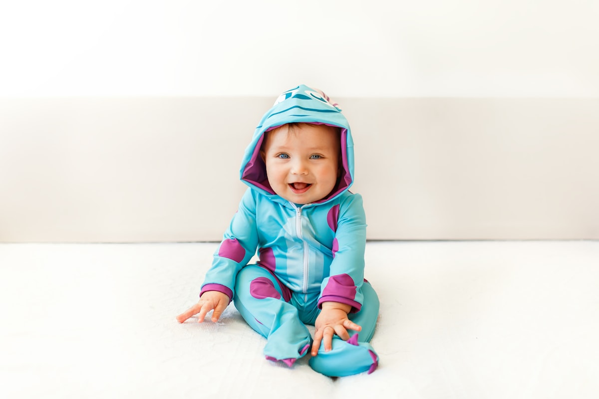 baby in blue and pink hoodie related to Discover the Beauty of Turquoise Baby Bedding