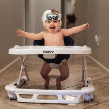 baby in white goggles on white and blue high chair related to Baby on the Move: The Ultimate Guide to Eddie Bauer Infant Travel Bed