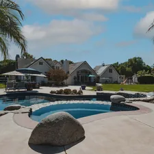 Backyard photo of large California home. related to Craft Your Backyard Paradise: Building a Majestic Chiminea