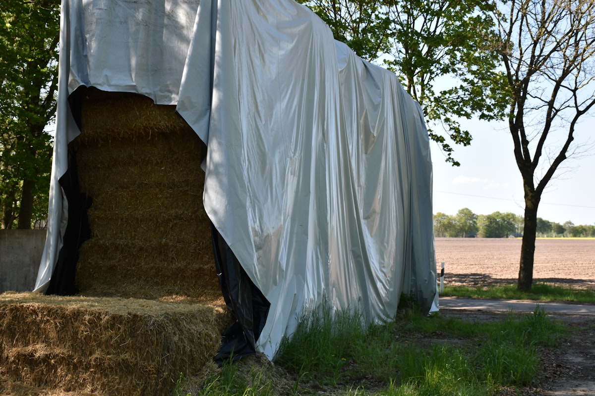 Bales of hay under the tarpaulin (Nature - Germany) related to The Ultimate Guide to Spray-On Bed Liners: Protecting Your Truck with Durability and Style