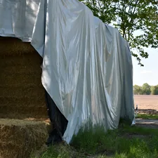Bales of hay under the tarpaulin (Nature - Germany) related to The Ultimate Guide to Spray-On Bed Liners: Protecting Your Truck with Durability and Style