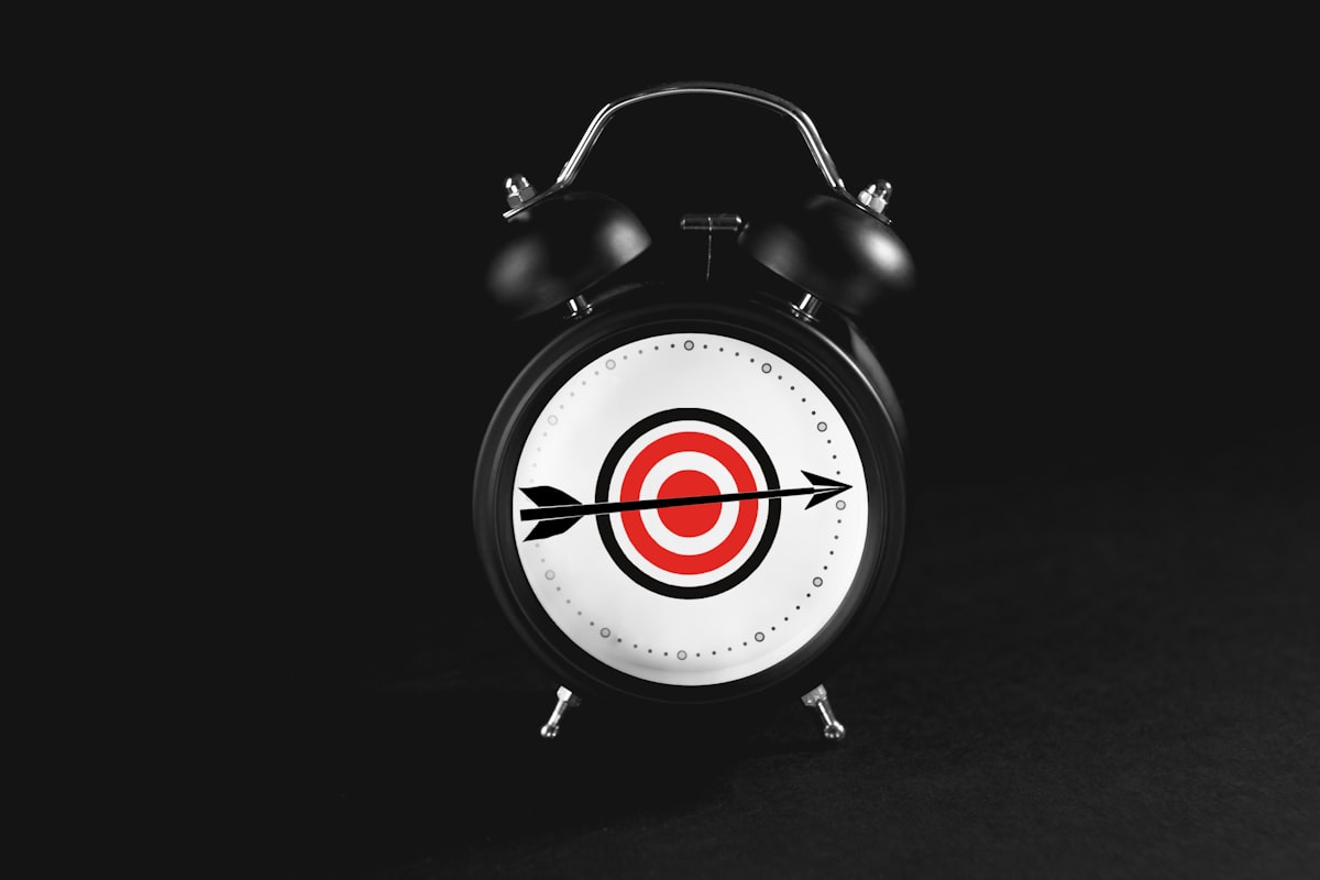 Black alarm clock with target on black background. related to Snuggle Up in Style: Explore the Ultimate Target Bedding Sets